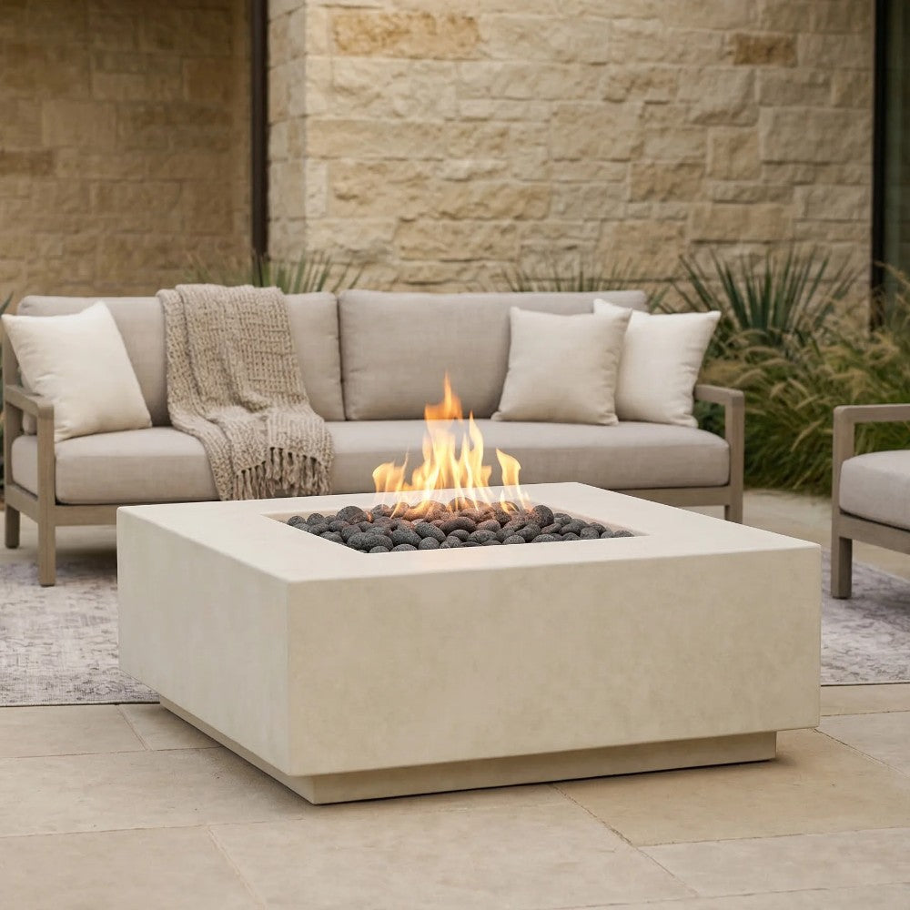 Light beige concrete gas fire pit with flames and burner rocks visible