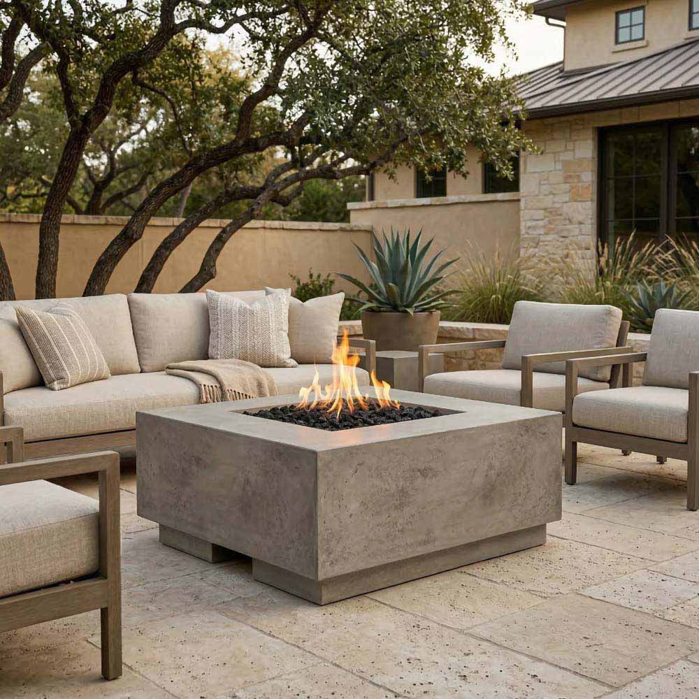 Medium gray concrete gas fire pit with flames, square firebox on patio