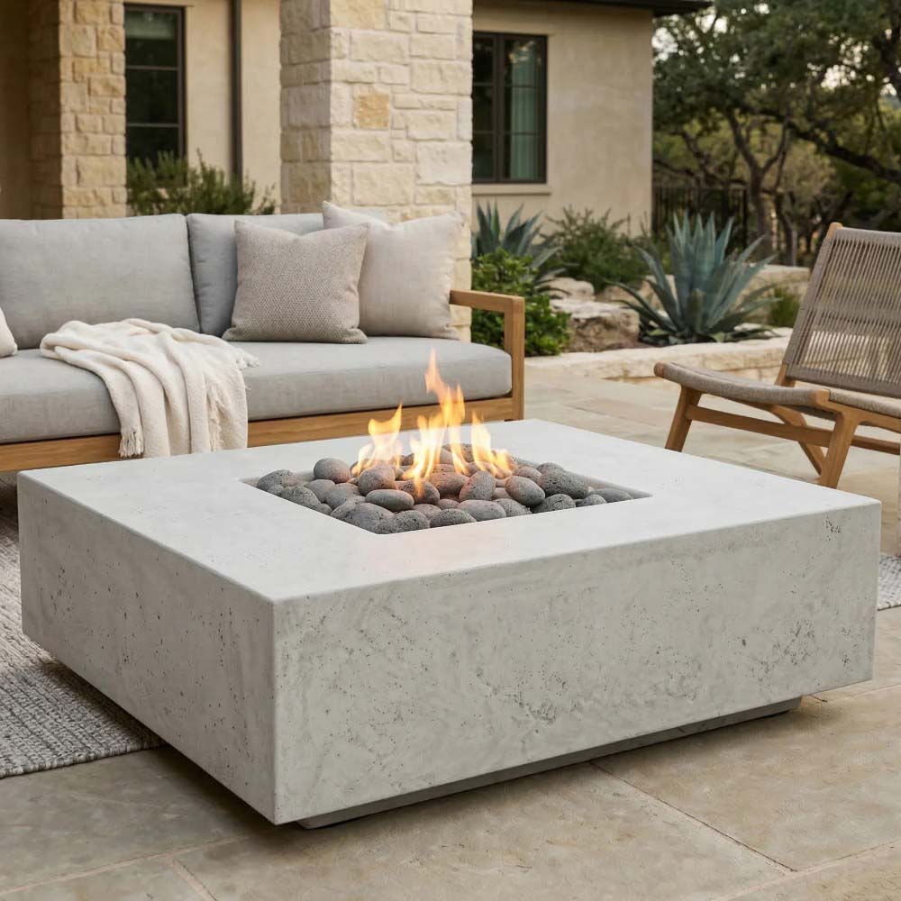 Light concrete gas fire pit with square center flame and stone fire media