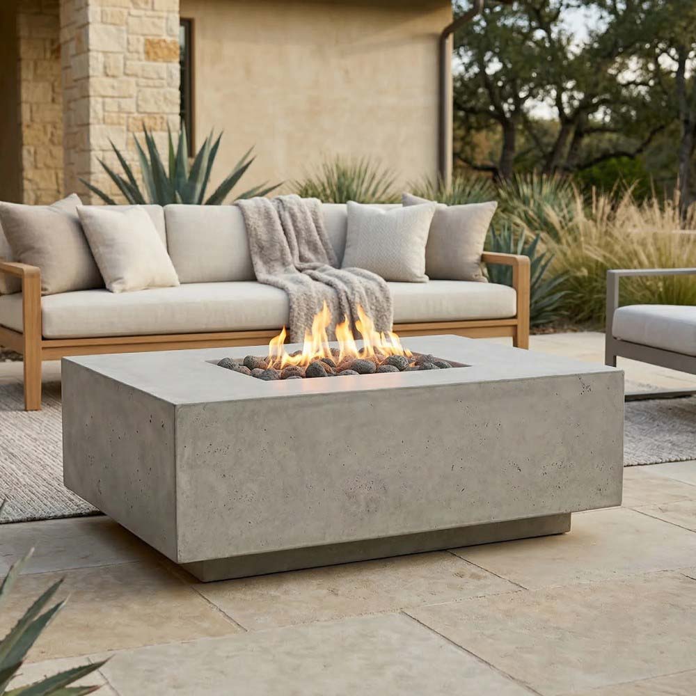 Light concrete gas fire pit with square flame bowl and burning fire bed