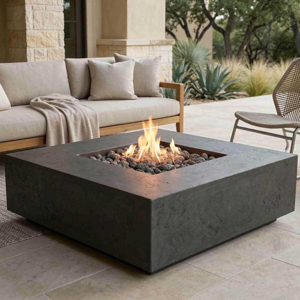 Dark concrete gas fire pit with square burner bowl and visible flame