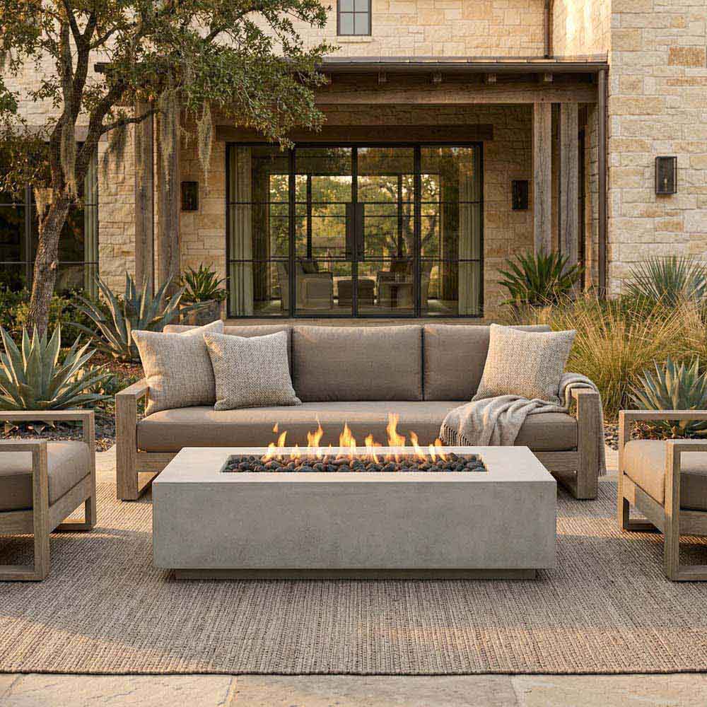 Outdoor concrete gas fire pit centered on patio, flames burning in dark tray