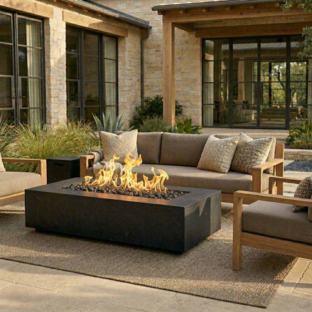 Front view concrete gas fire pit with glowing flames, dark grey finish