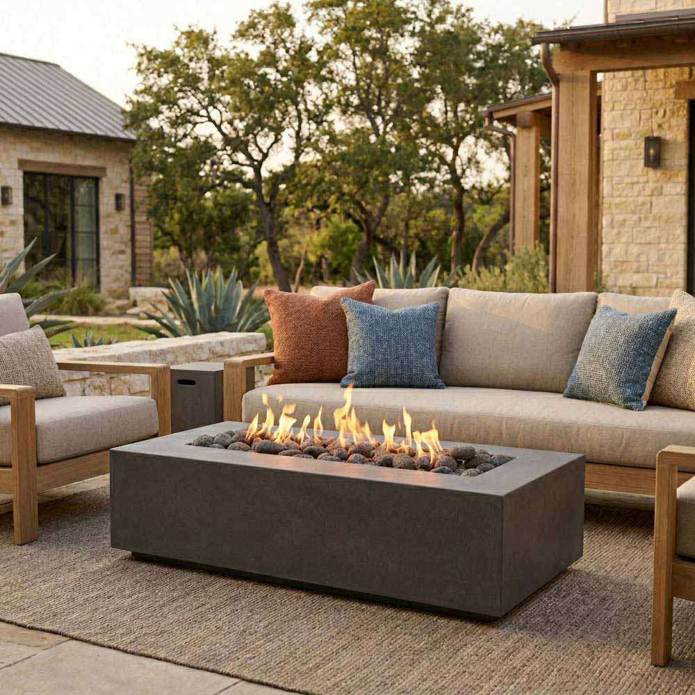 Rectangular concrete gas fire pit with active flames, dark burner tray