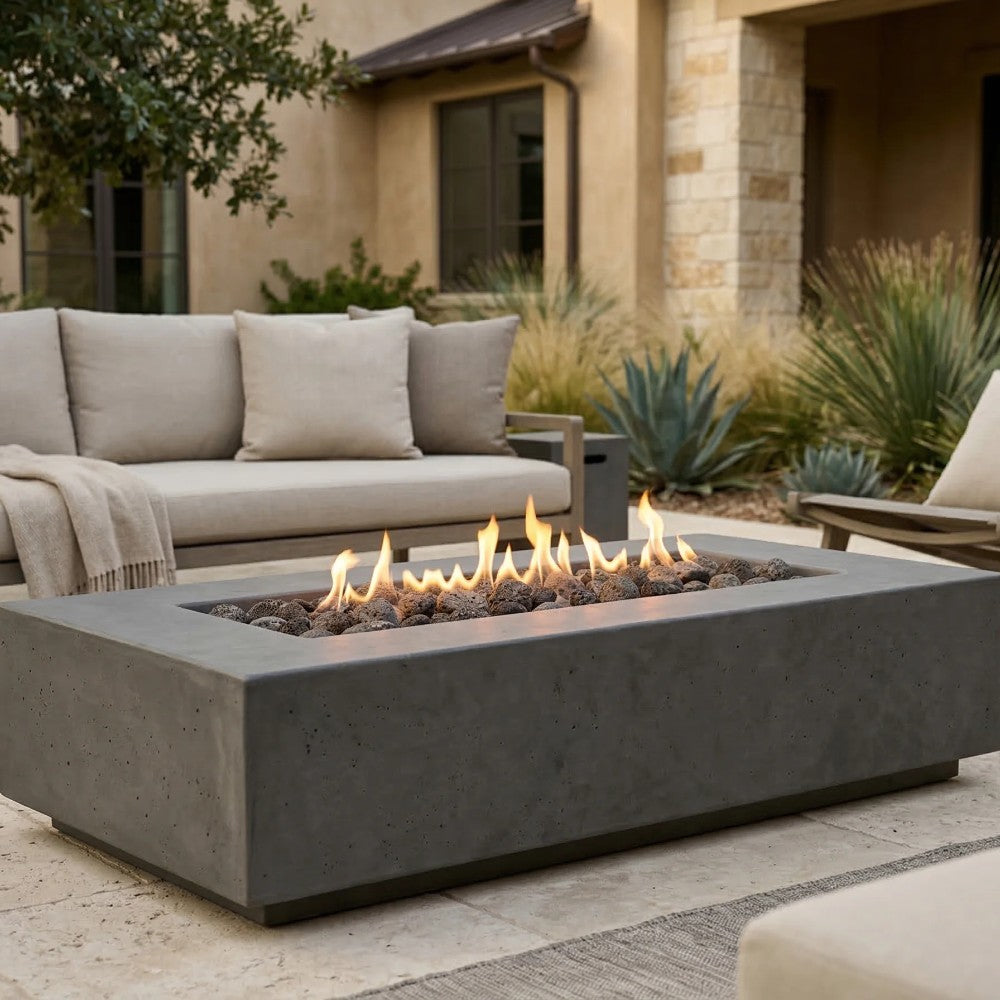 Gray concrete gas fire pit front view with square opening and flames