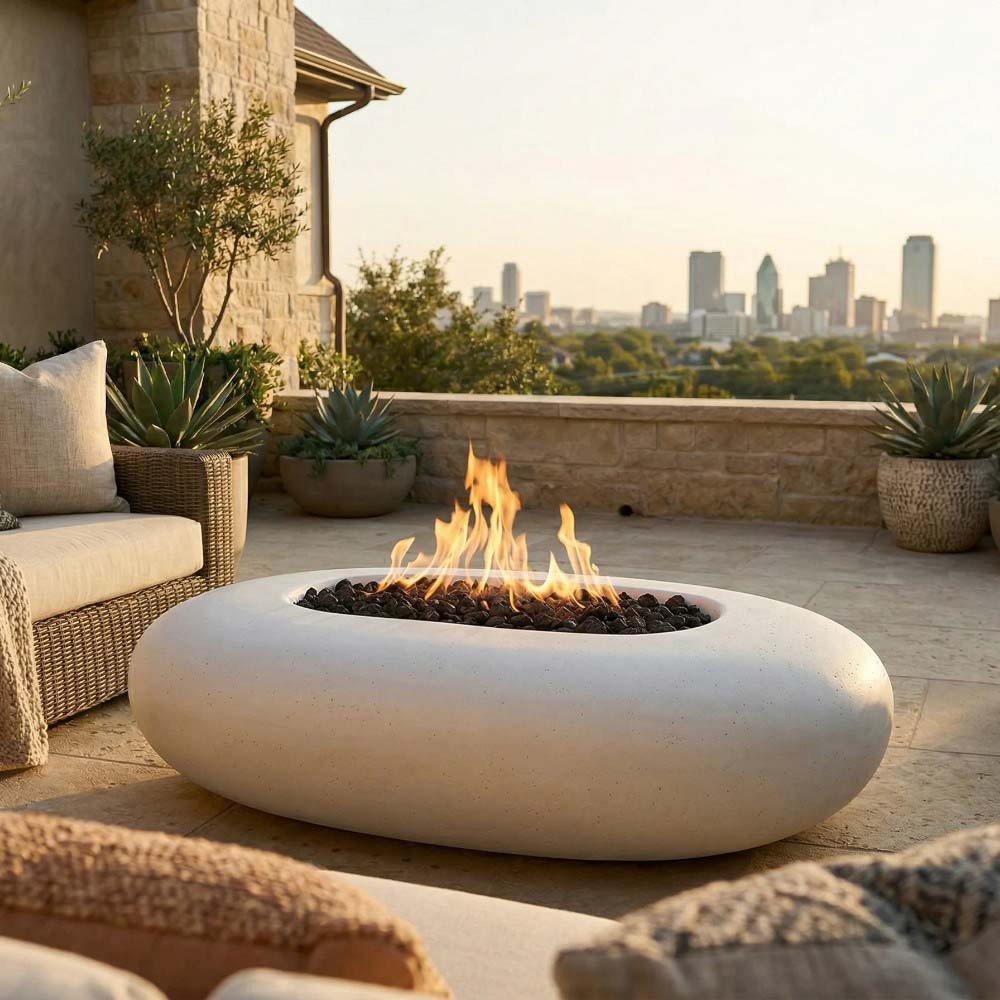 Oval pebble-concrete gas fire pit with visible flames in dark fire bed