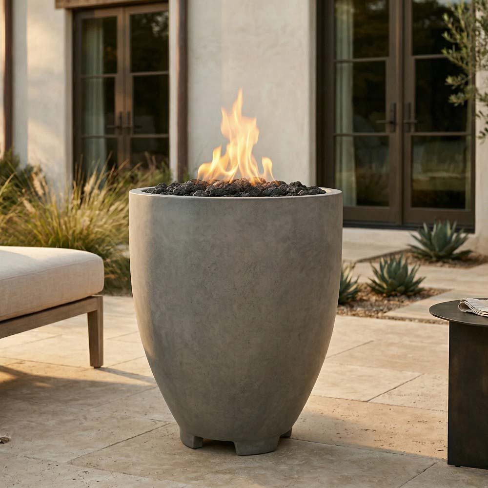 Light gray concrete gas fire pit with open bowl and visible flames