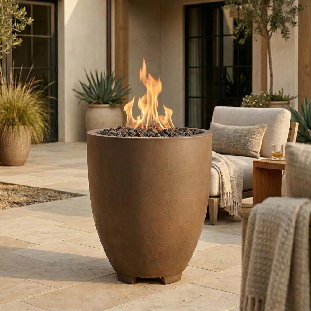 Warm tan concrete gas fire pit with open bowl and burning flames