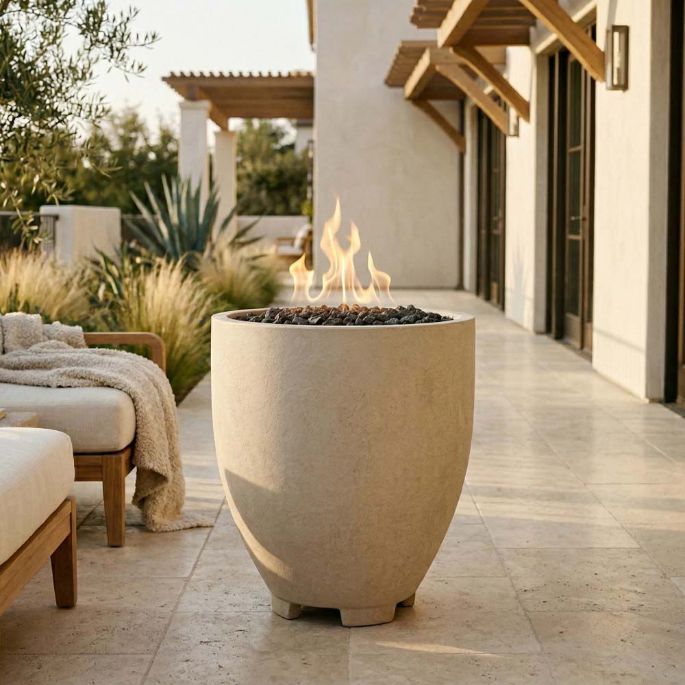 Light concrete gas fire pit with open bowl and burning flames outdoors