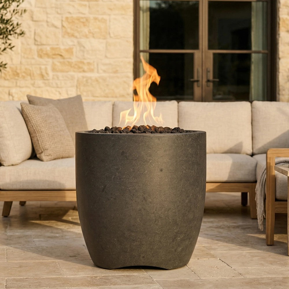 Dark gray concrete gas fire pit bowl with flames over black fire media