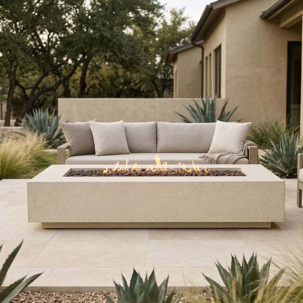 Light concrete gas fire pit with flames and gravel-filled rectangular tray
