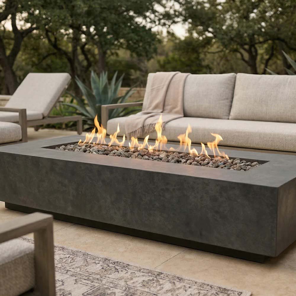 Dark gray concrete gas fire pit with flames across rectangular burner tray