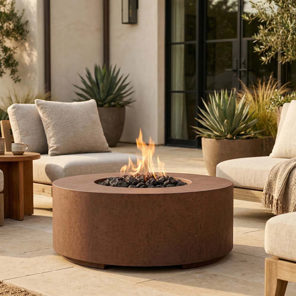 Round concrete gas fire pit in warm brown with flame over lava rocks