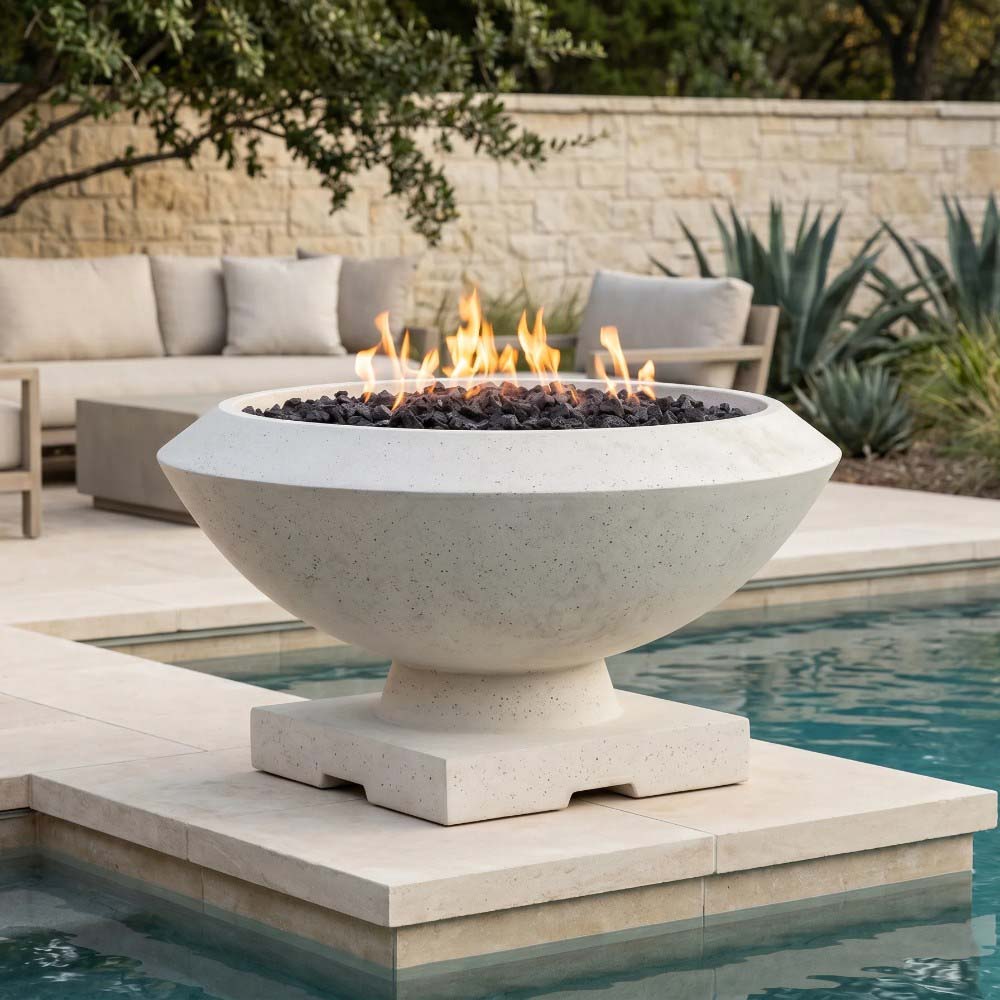 Light concrete gas fire bowl with burning fuel bed, on a square platform near seating