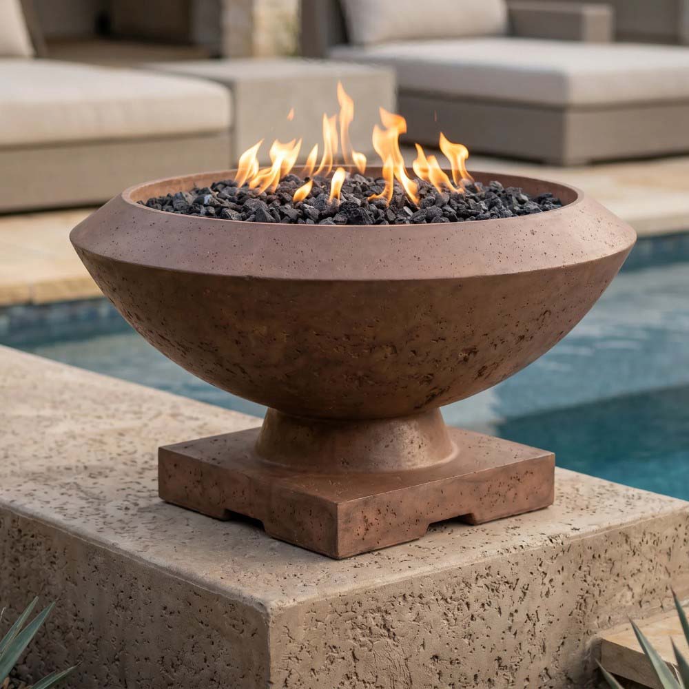 Close-up of concrete gas fire bowl with flame over lava rocks on a flat stone base