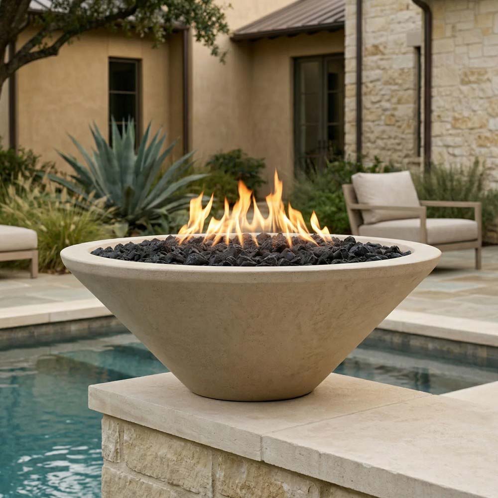 Concrete pedestal gas fire pit in light beige with flames over black lava rocks
