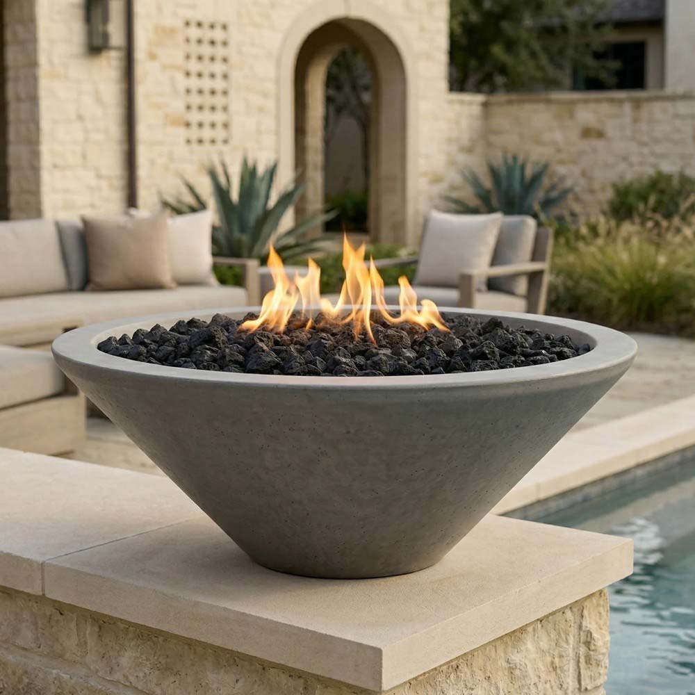 Concrete pedestal gas fire pit with light gray finish, flames over black lava rocks
