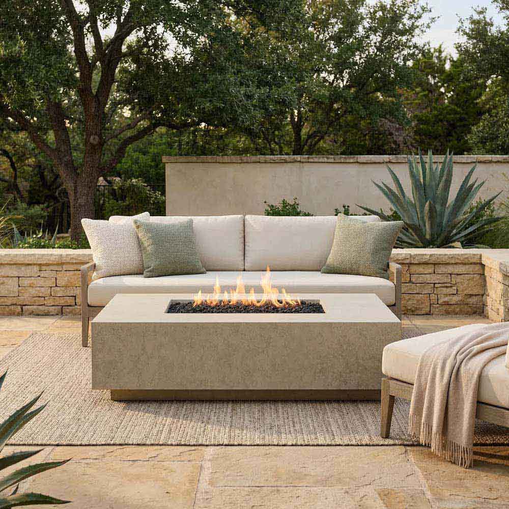 Outdoor concrete gas fire pit with visible flames in square burner base