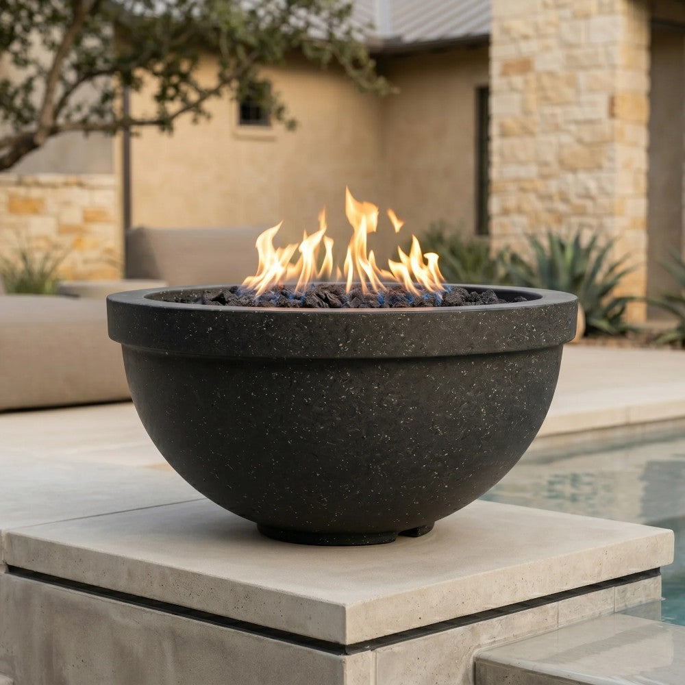 Black concrete gas fire bowl with flames and black lava rocks