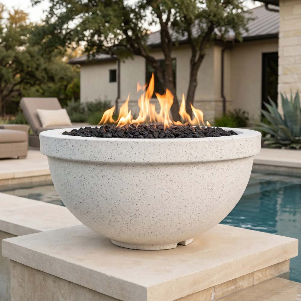 Light gray speckled concrete gas fire bowl with flames and black lava rocks