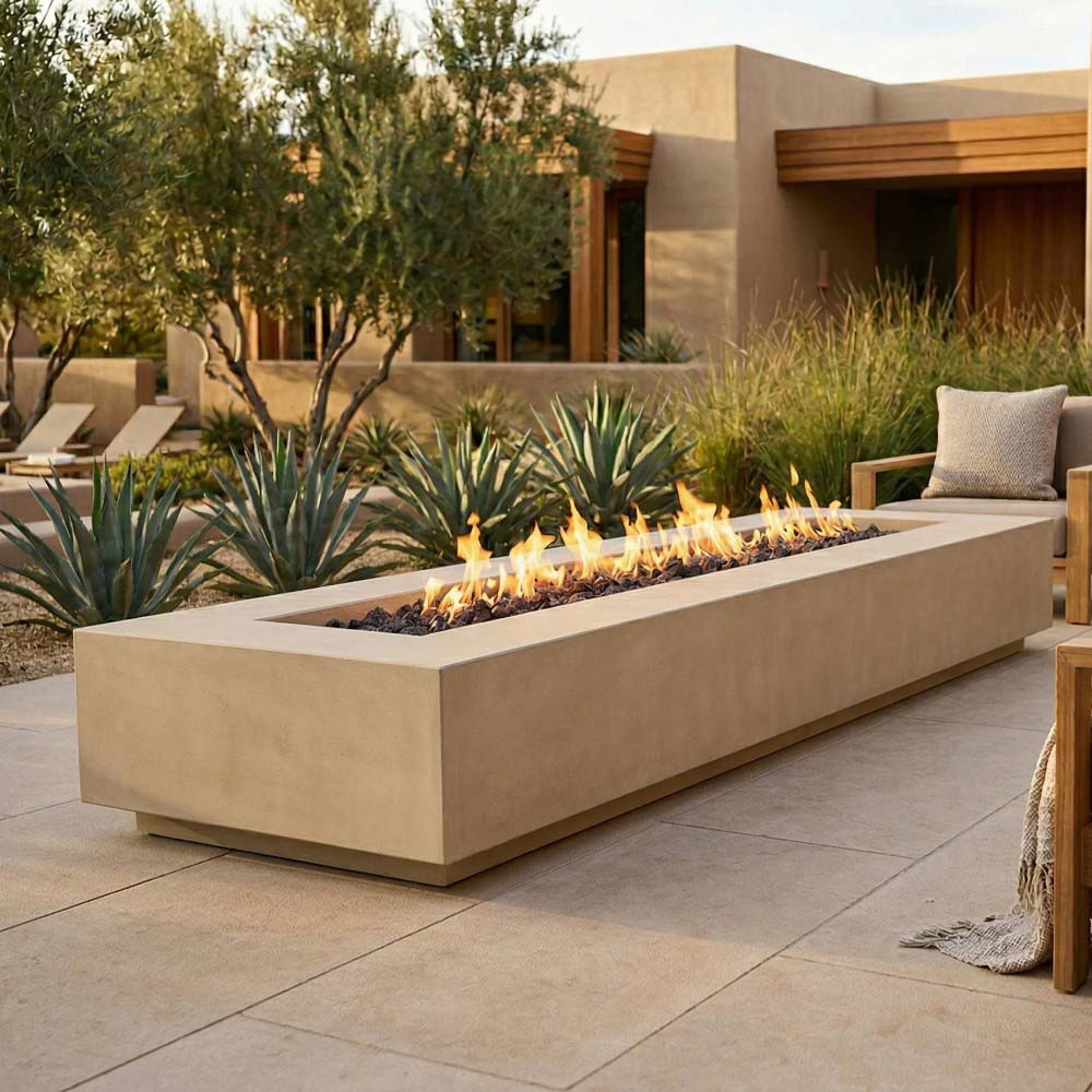 Light tan concrete gas fire pit with flames burning inside rectangular firebox
