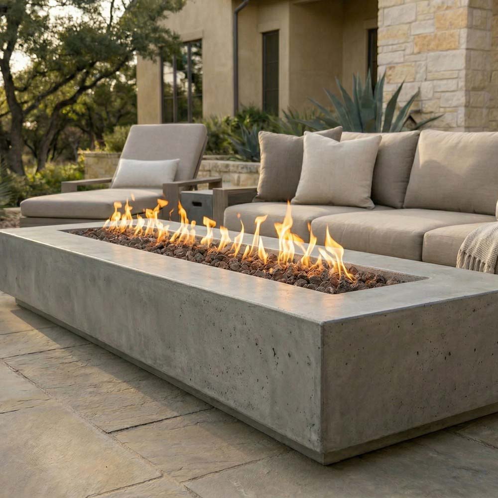 Dark gray concrete gas fire pit with visible flames in outdoor rectangular bowl