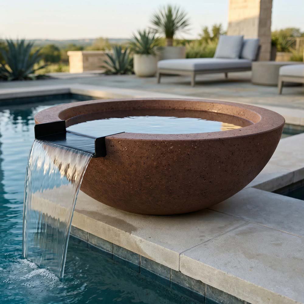 Brown concrete fire and water bowl with spillway water stream at pool edge