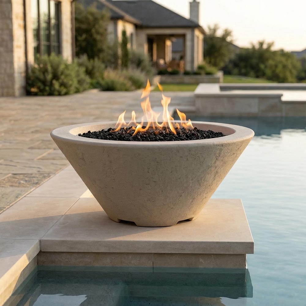 Concrete gas fire bowl on stone base with flames and dark lava rock, light gray finish