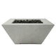 Tall concrete gas fire pit with black lava rocks, square opening, light gray finish.
