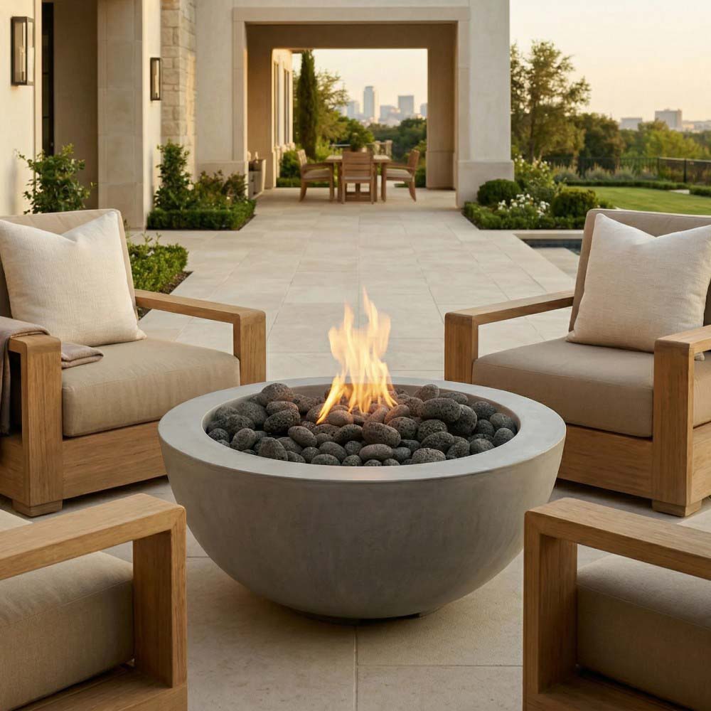 Light gray concrete gas fire pit with flames and round burner filled with dark lava rocks.