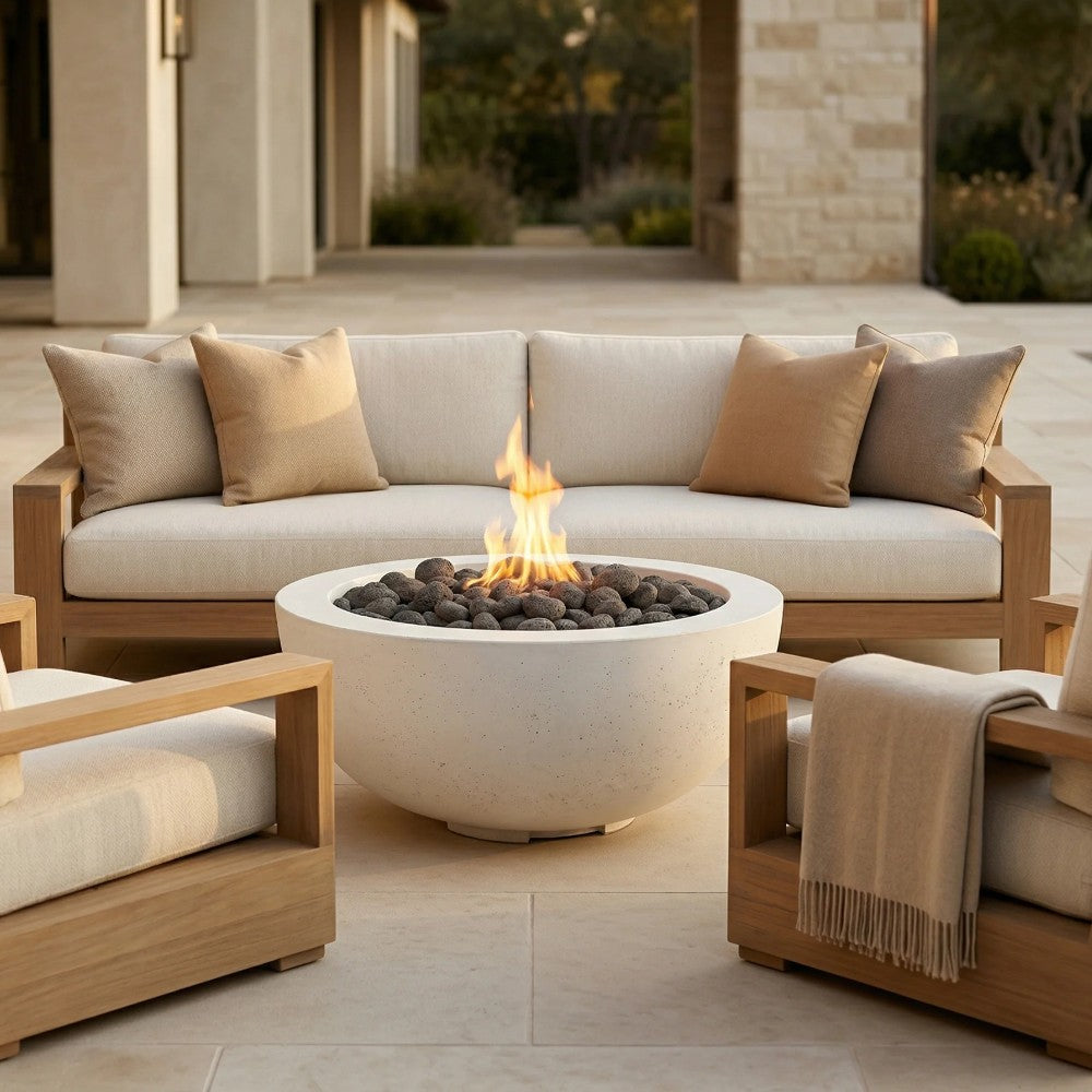 Concrete gas fire pit with light concrete bowl, flames, and black burner center.