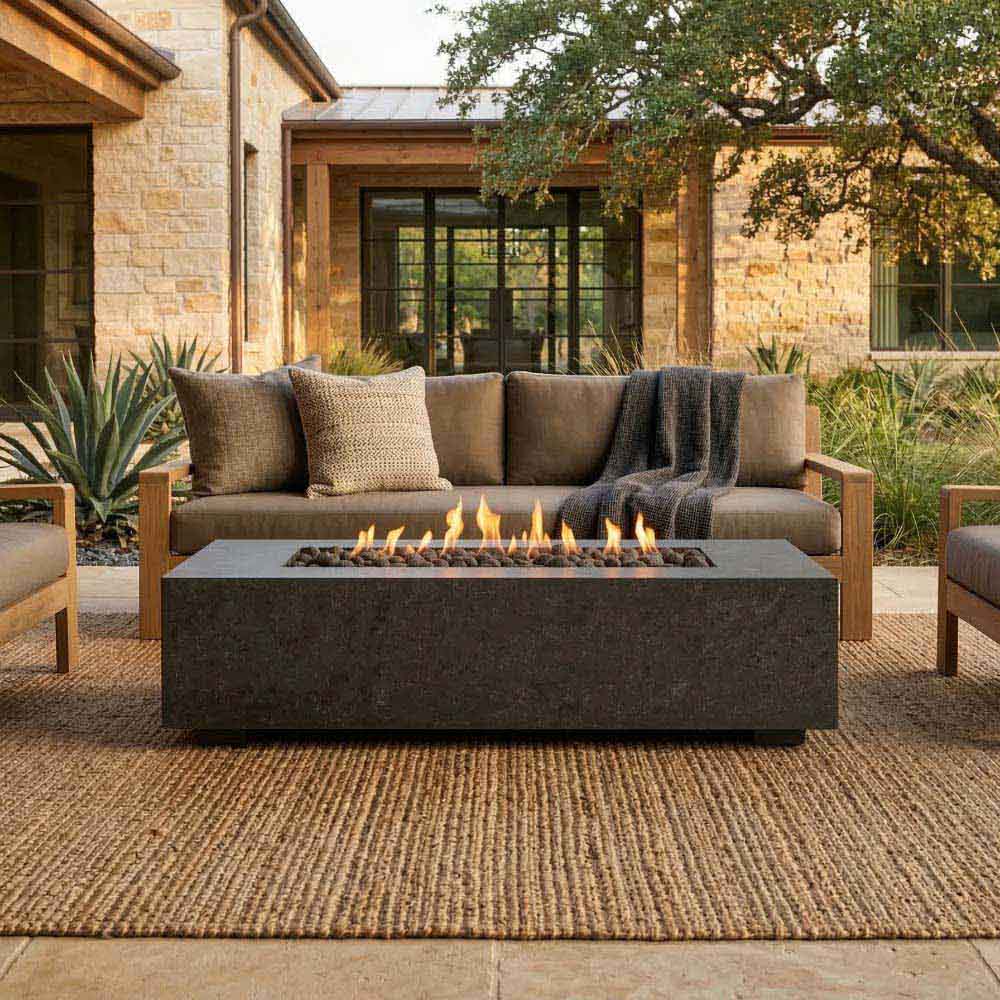 Rectangular concrete gas fire pit with flame bed burning along the front edge