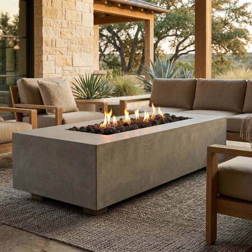 Narrow rectangular concrete gas fire pit with active flames