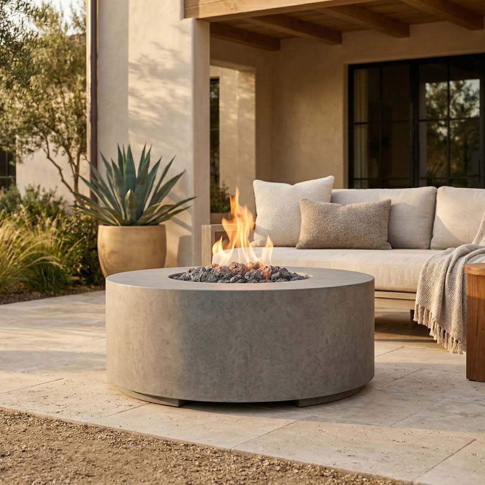 Round concrete gas fire pit with flames and lava rocks, light gray finish