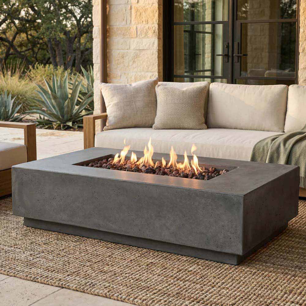 Gray rectangular concrete gas fire pit with flames, set into a patio seating area