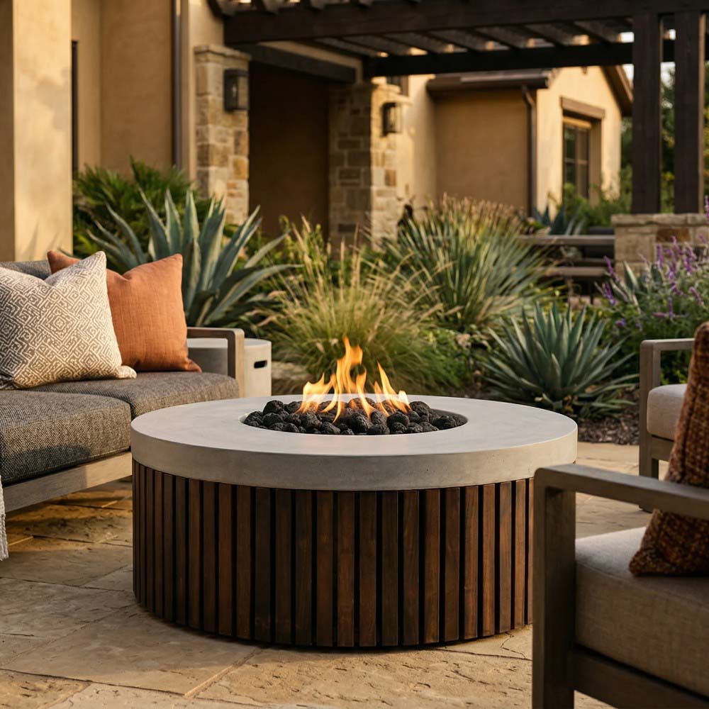 Round outdoor gas fire pit with flame, speckled concrete top and wood-slat sides