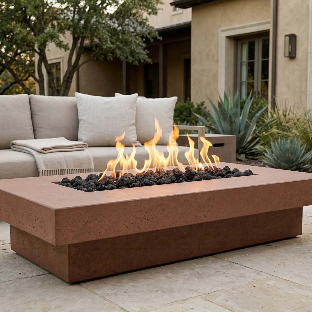 Rectangular concrete gas fire pit with flames and lava rocks, warm-toned concrete finish