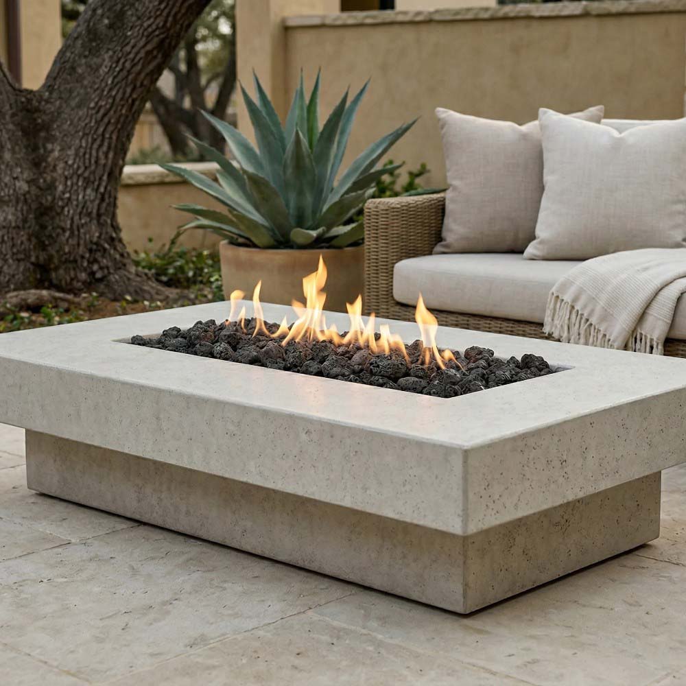 Rectangular concrete gas fire pit with flames and lava rocks in front burner bed