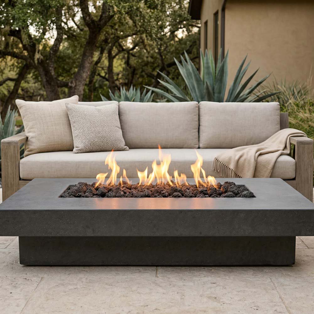 Low rectangular concrete gas fire pit with flames and lava rocks, front-facing view