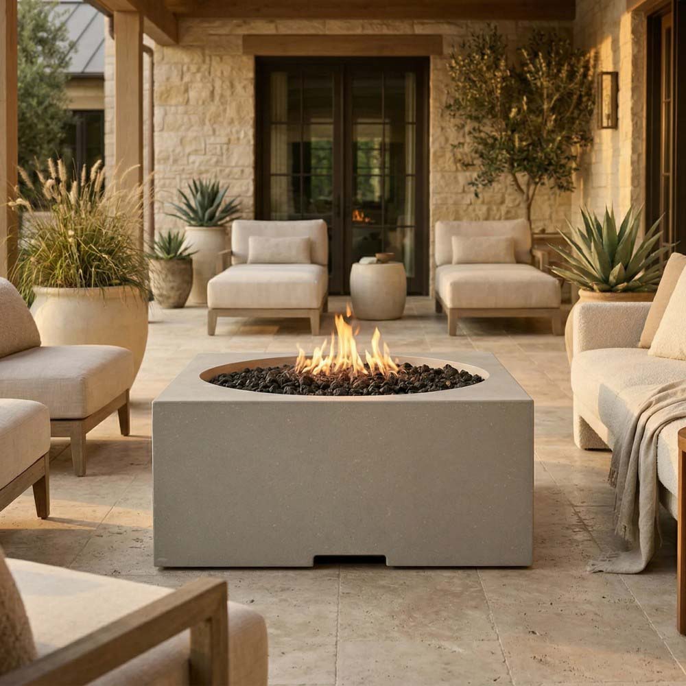 Light-gray concrete square gas fire pit with round burner and visible flame
