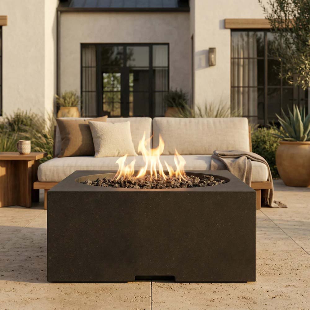 Dark concrete square gas fire pit with round burner bowl and visible flame