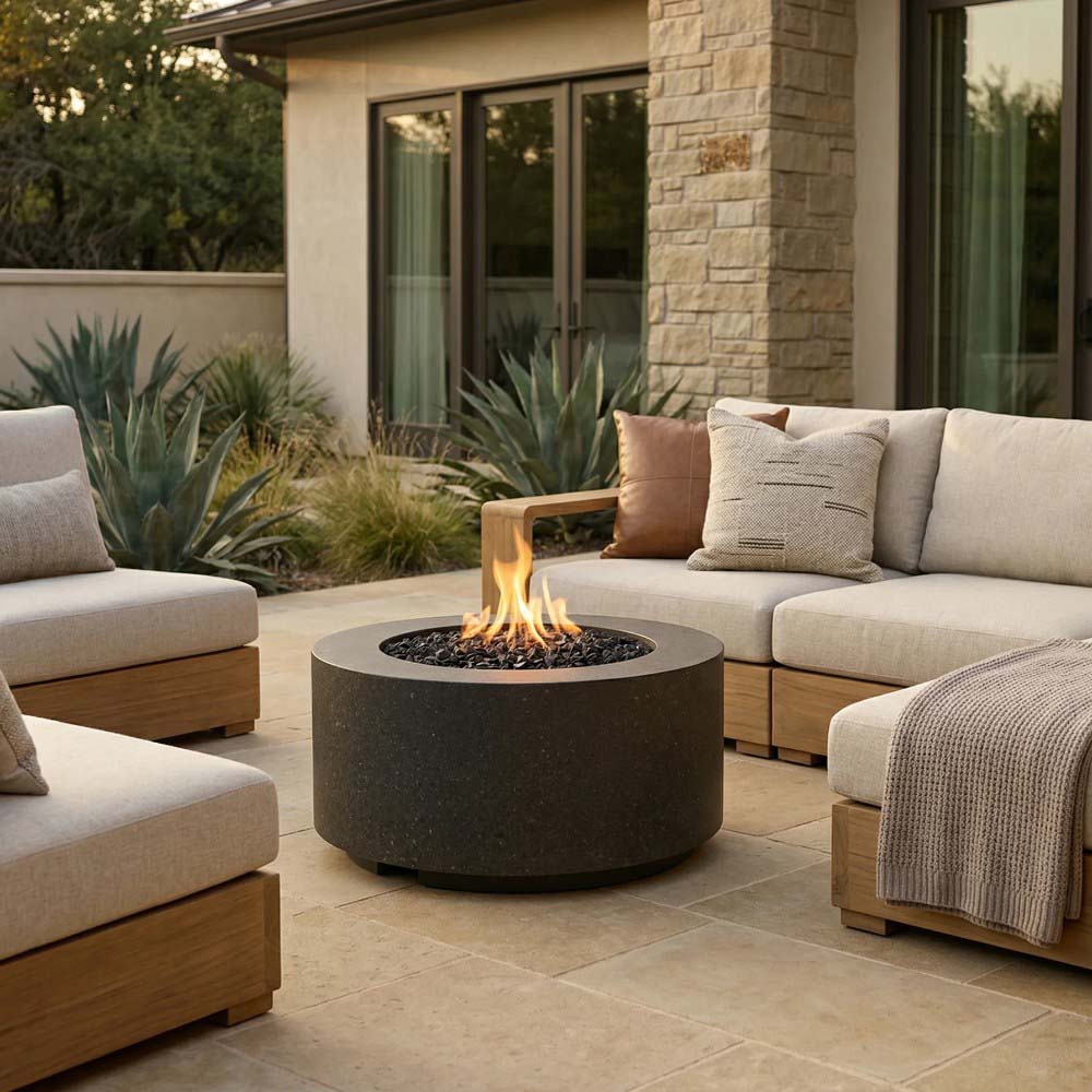 Charcoal black concrete cylindrical gas fire pit with round burner opening and flames