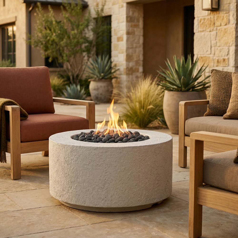 Cylindrical concrete gas fire pit with visible flame and burner rocks