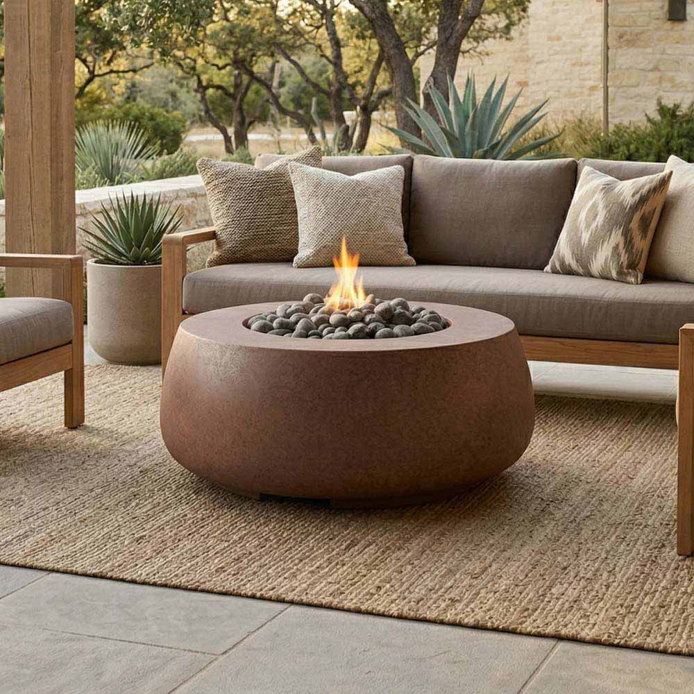 Round brown concrete gas fire bowl with flames above dark lava rocks