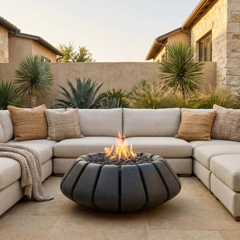 Dark gray concrete gas fire bowl with segmented sides and burning flame