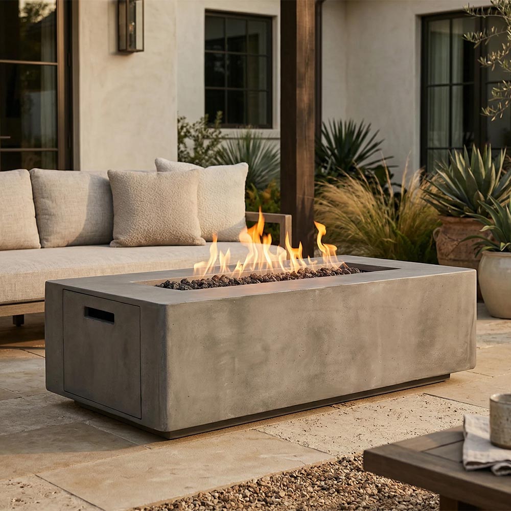 Gray concrete gas fire pit with open flame, rectangular body and side access door