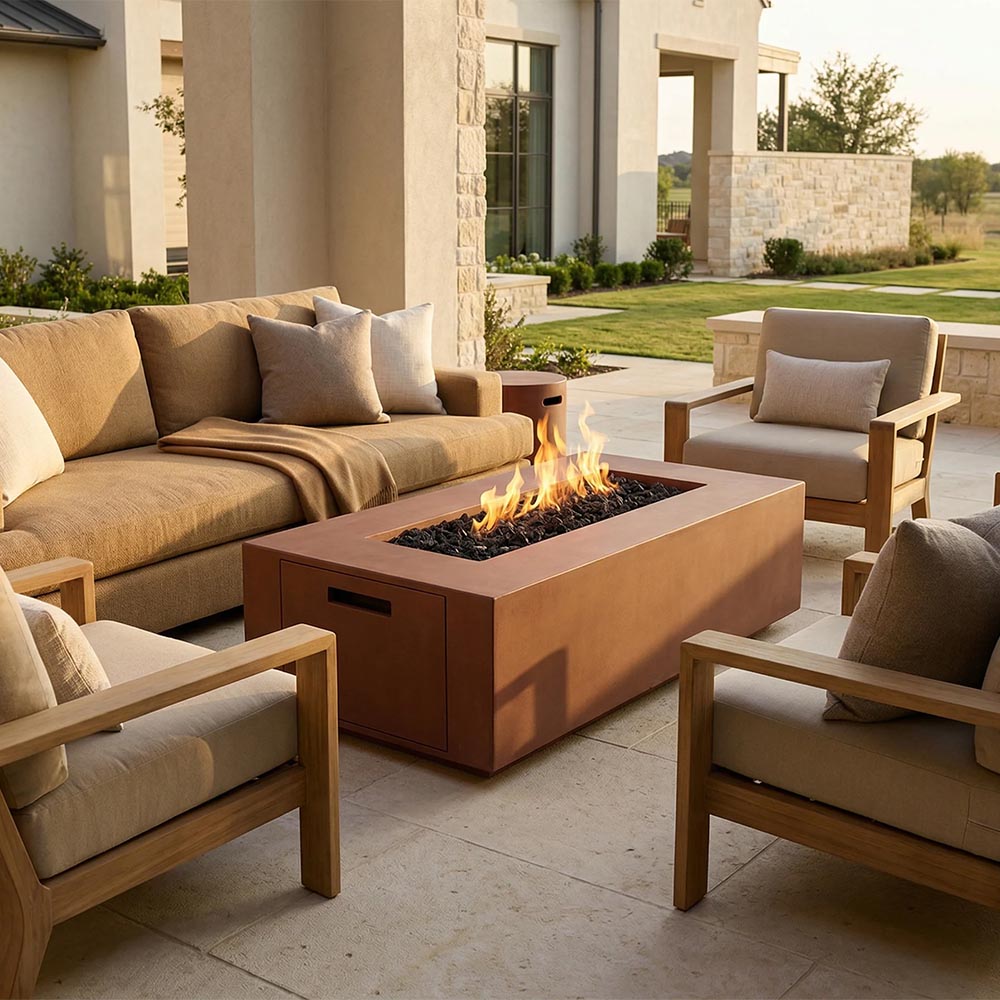 Tan concrete gas fire pit with visible flame, rectangular firebox and side access door