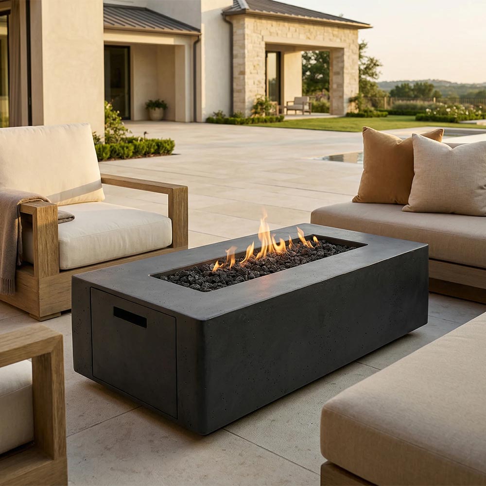 Dark gray concrete gas fire pit with open flame, rectangular body and side access door