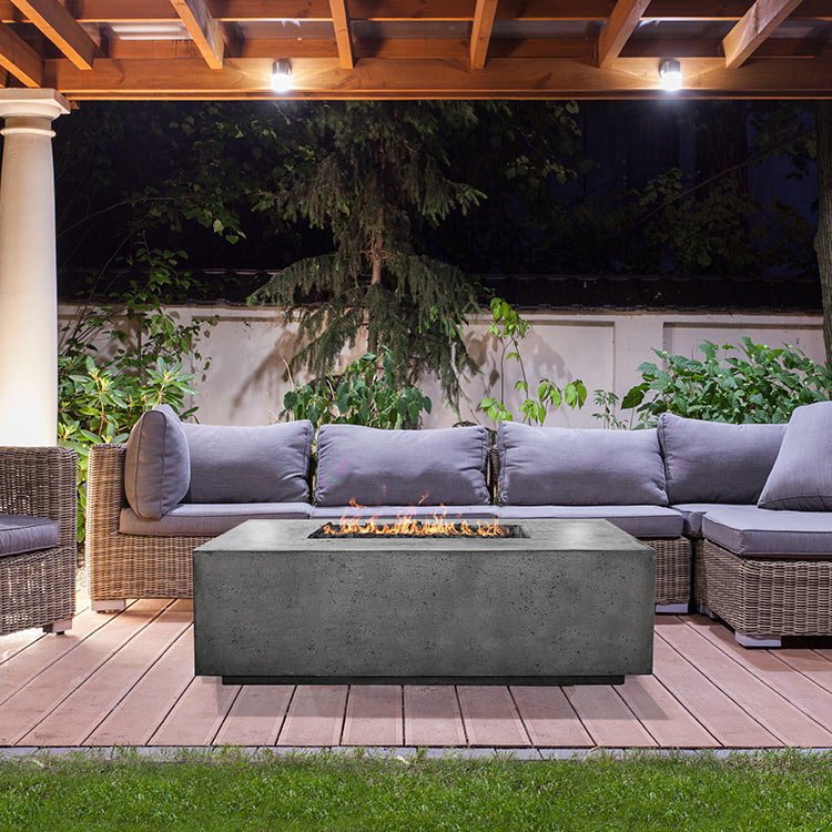 Rectangular concrete gas fire pit with visible flames in the recessed burner opening