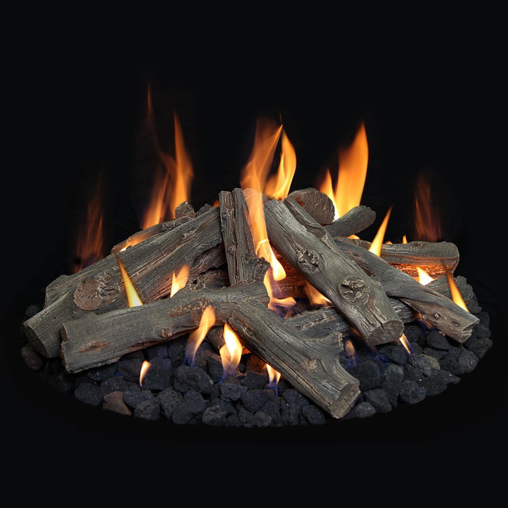 Fire pit with dark logs arranged over black lava rock with multiple burning flames